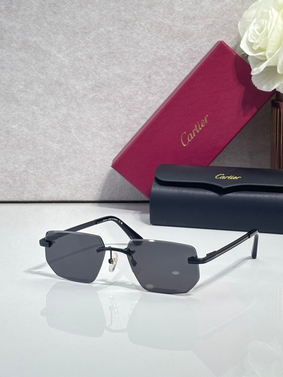 Cartier glasses with dark frames and gold arms, showing gray tinted lenses from the side