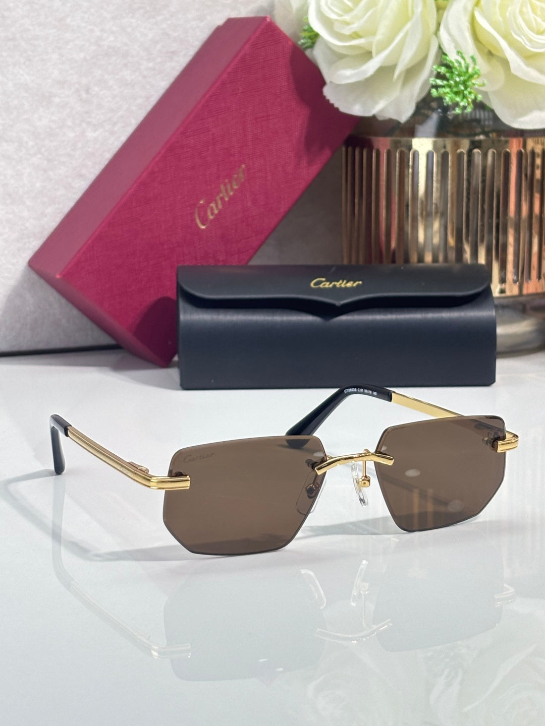 Cartier glasses with gold temples and brown tinted lenses, front view
