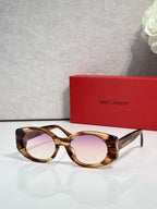Tortoiseshell cat-eye sunglasses with rose-tinted lenses and gold YSL emblem
