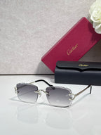 Cartier eyeglasses with gold metal frame, dark arms, and gray-tinted lenses