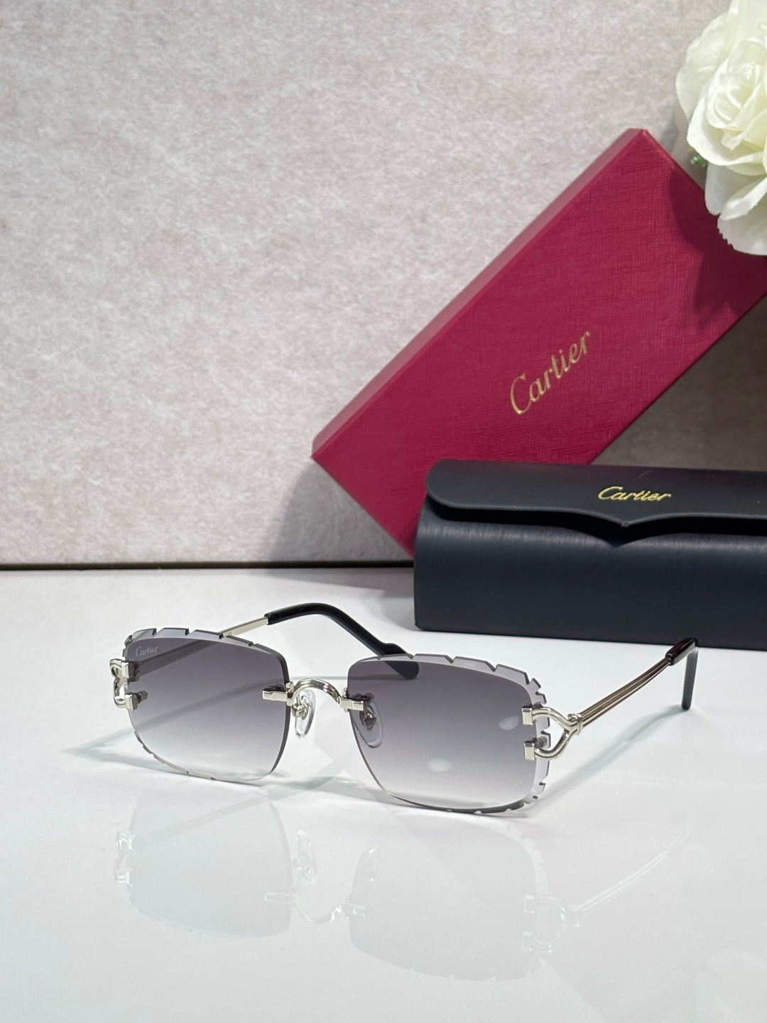 Cartier eyeglasses with gold metal frame, dark arms, and gray-tinted lenses