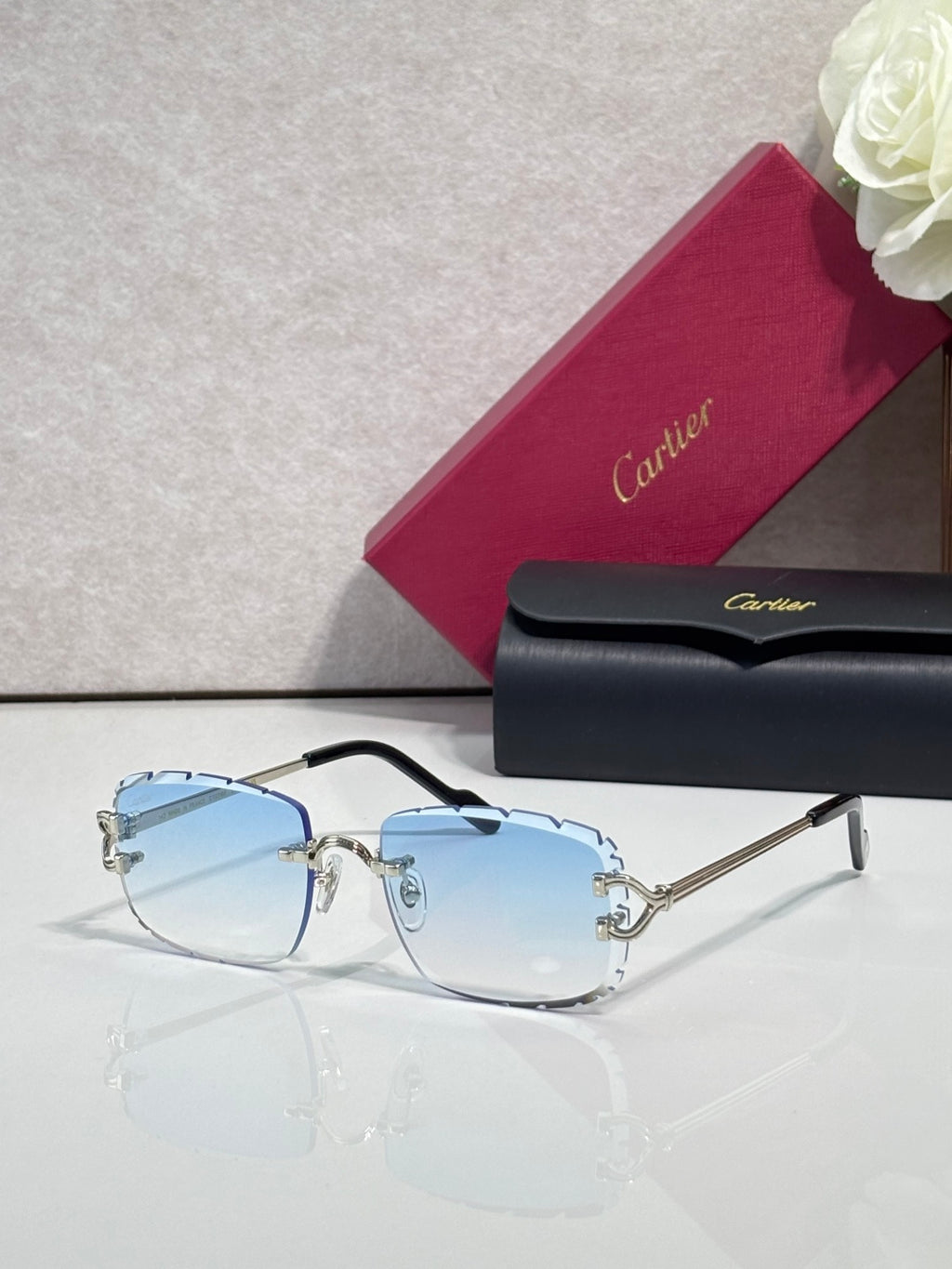 Cartier eyeglasses with gold metal frame, light blue-tinted lenses, and dark arms