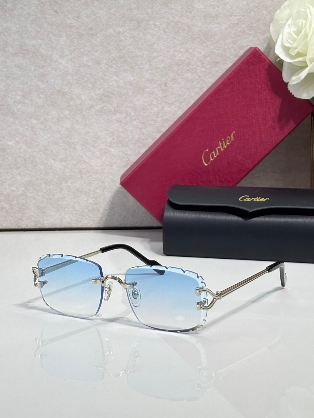 Cartier eyeglasses with gold metal frame, light blue-tinted lenses, and dark arms