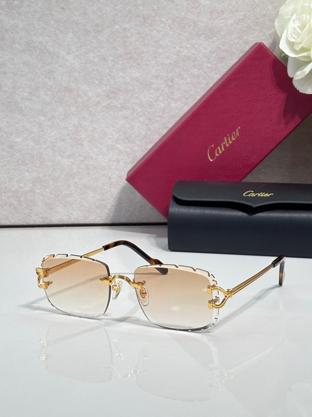 Cartier eyeglasses with gold metal frame, dark arms, and light tan-tinted lenses