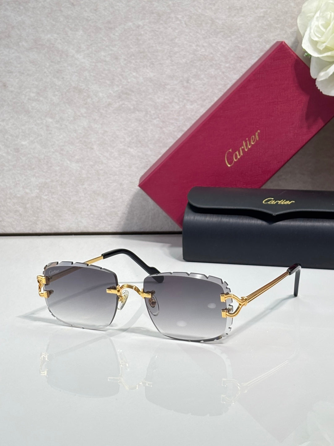 Cartier eyeglasses with dark frame, gold-tone metal, and gray gradient lenses