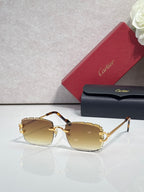 Cartier eyeglasses with gold metal frame, dark arms, and amber-tinted lenses
