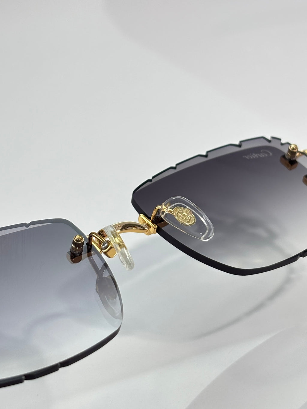 Eyeglasses with dark frame, gold hinge details, and smoky gray lenses