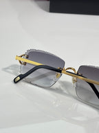 Dark eyeglasses with gold bar temples and gray gradient lenses