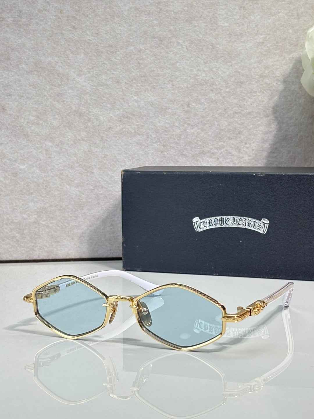 Metal round sunglasses with gold frame and light blue lenses