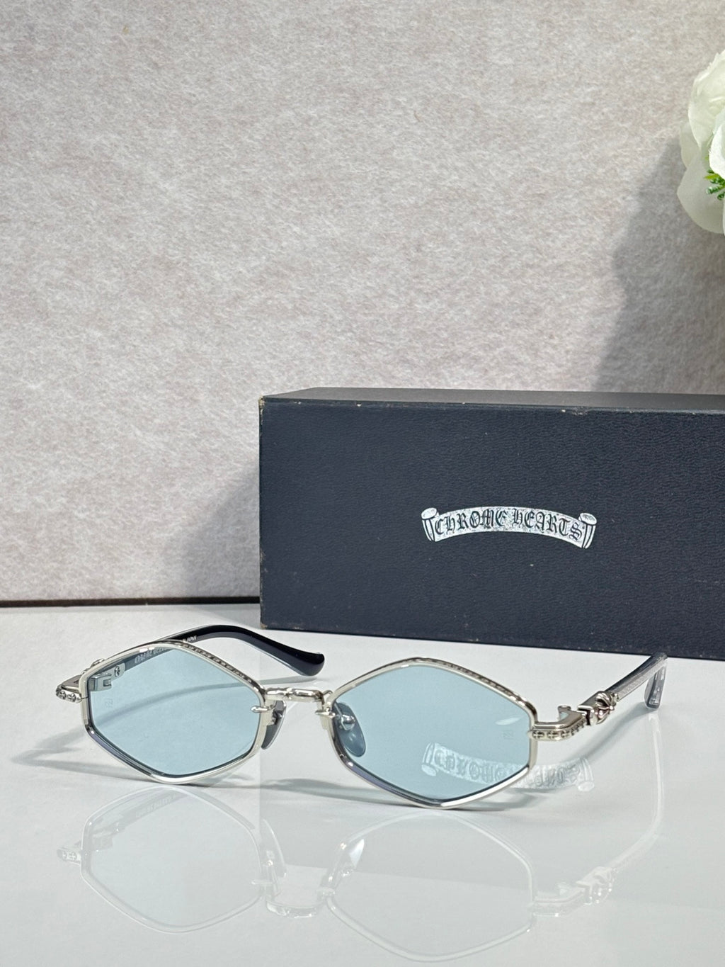 Metal round sunglasses with clear frame and light blue lenses