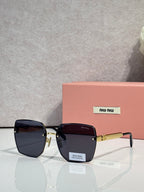 MiuMiu square black glasses with dark tinted lenses and gold-tone hinges