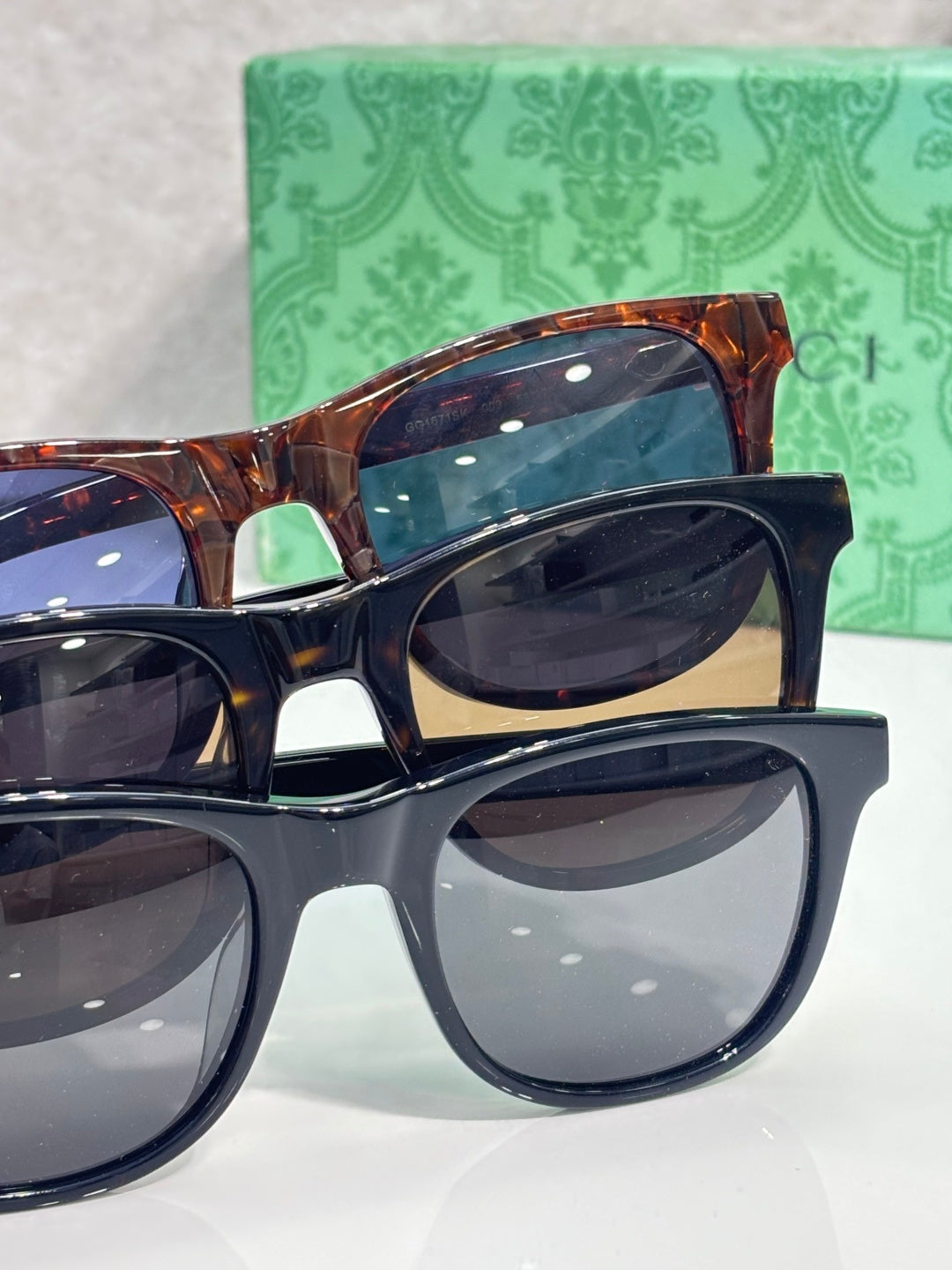 Gucci sunglasses set with tortoiseshell and black frames, dark lenses