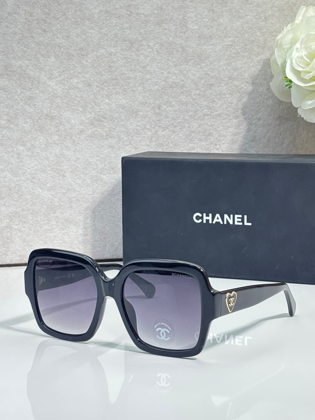 Square acetate sunglasses, dark blue/black frame with purple-tinted lenses and Chanel logo