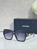 Square acetate sunglasses, navy/black frame with dark lenses and Chanel logo