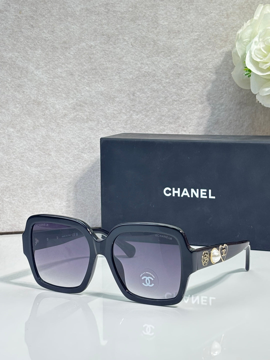 Square acetate sunglasses, navy/black frame with dark lenses and Chanel logo