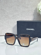 Square acetate sunglasses, dark tortoise frame with brown gradient lenses and Chanel logo