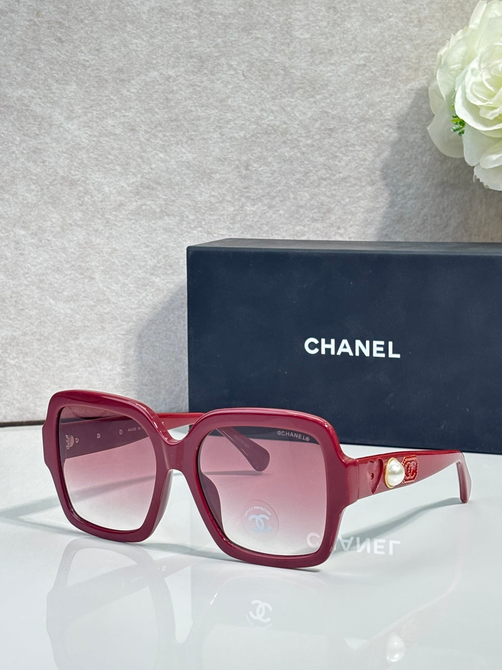 Square acetate sunglasses, burgundy frame with pink tint lenses and Chanel logo