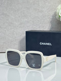 Square acetate sunglasses, white frame with dark lenses and Chanel logo