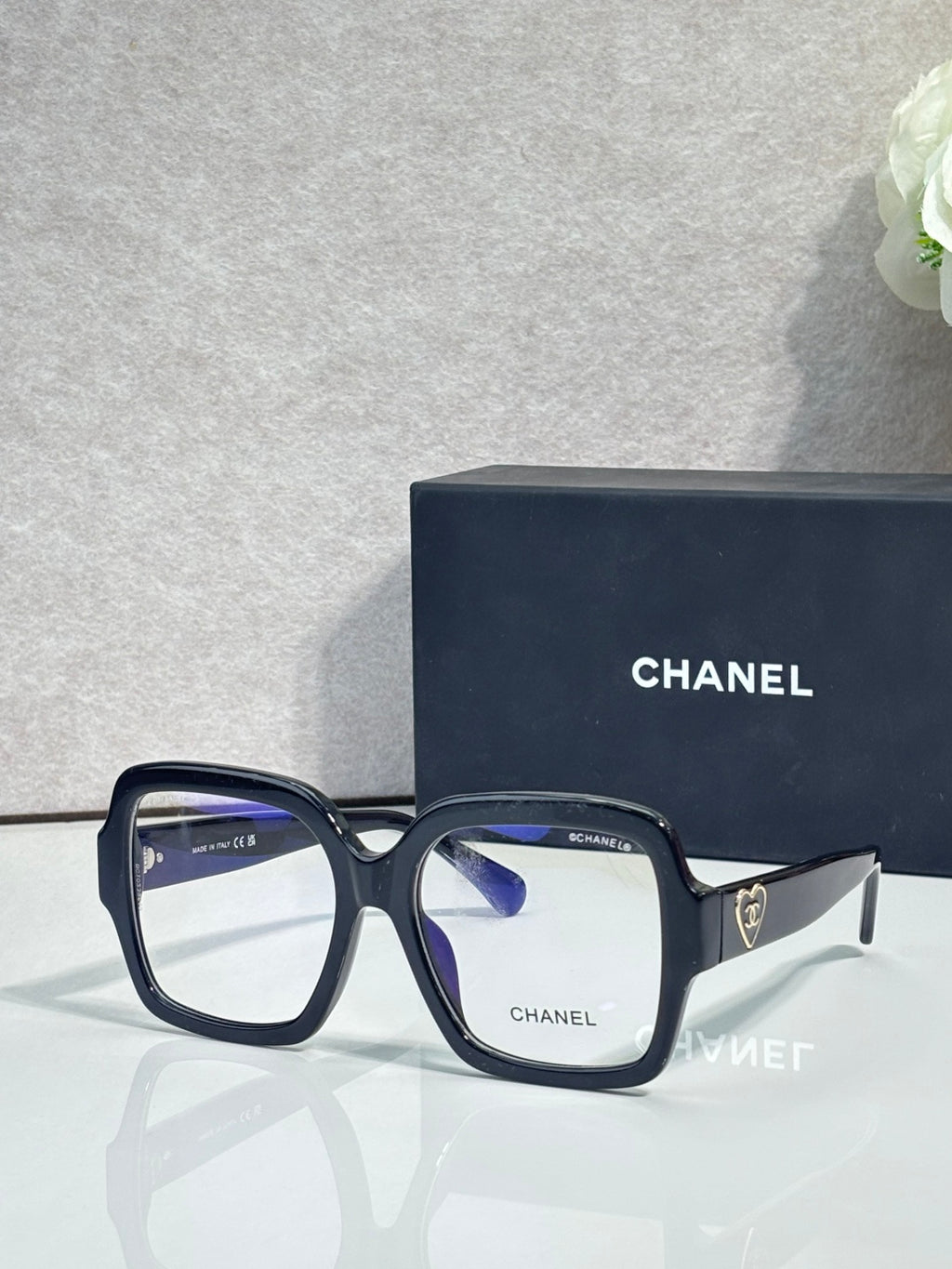 Square acetate sunglasses, black frame with light lenses and Chanel logo