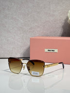 Sunglasses with brown gradient lenses, gold-tone frame, and decorative temple bars