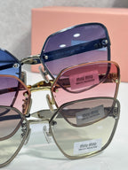 Assorted sunglasses with purple, pink, and clear lenses; gold-tone metal frames