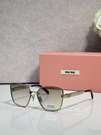 Sunglasses with gray lenses, dark frame, and gold-tone temple details