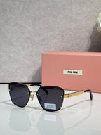 Sunglasses with navy lenses, black frame, and gold-tone temple arms