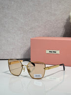 Sunglasses with amber lenses, gold-tone frame, and clear-gray temple accents
