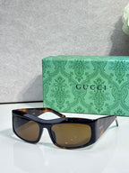 Dark blue cat-eye eyeglasses with brown lenses and glossy tort-style temple accents