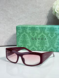 Dark blue cat-eye eyeglasses with burgundy lenses and white side logo accents