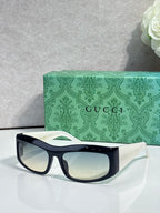 Black cat-eye eyeglasses with light lenses and small gold-tone logo at temple