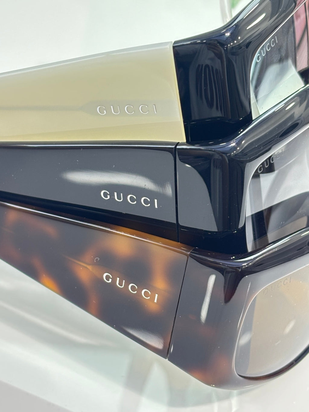 Navy rectangular eyeglasses with reflective lenses and Gucci logo detailing on frame