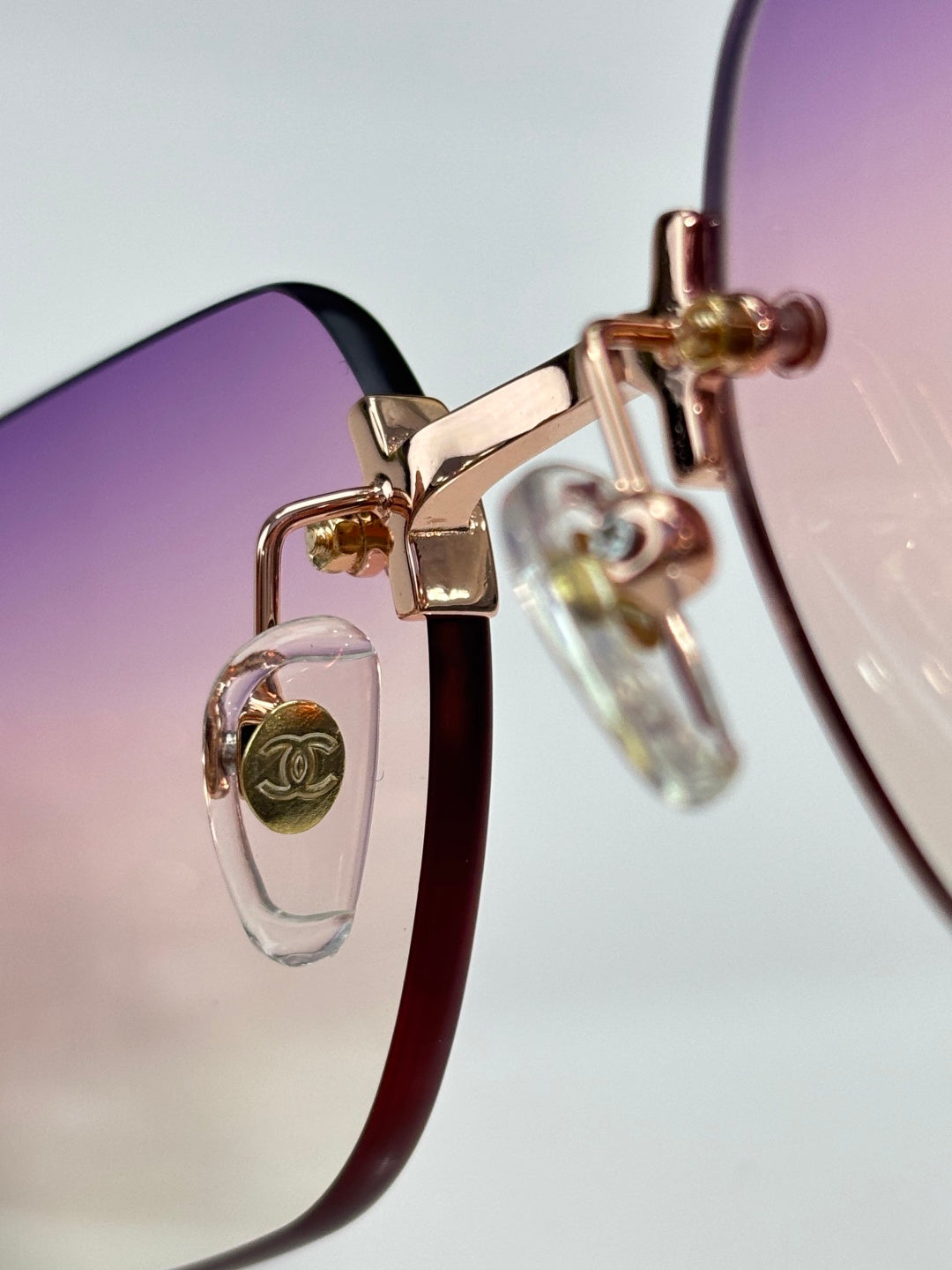 Chanel sunglasses hinge detail with rose-gold metal and clear plastic loop