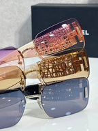 Chanel sunglasses with dark blue lenses, gold frame, pink and gold patterned temple caps