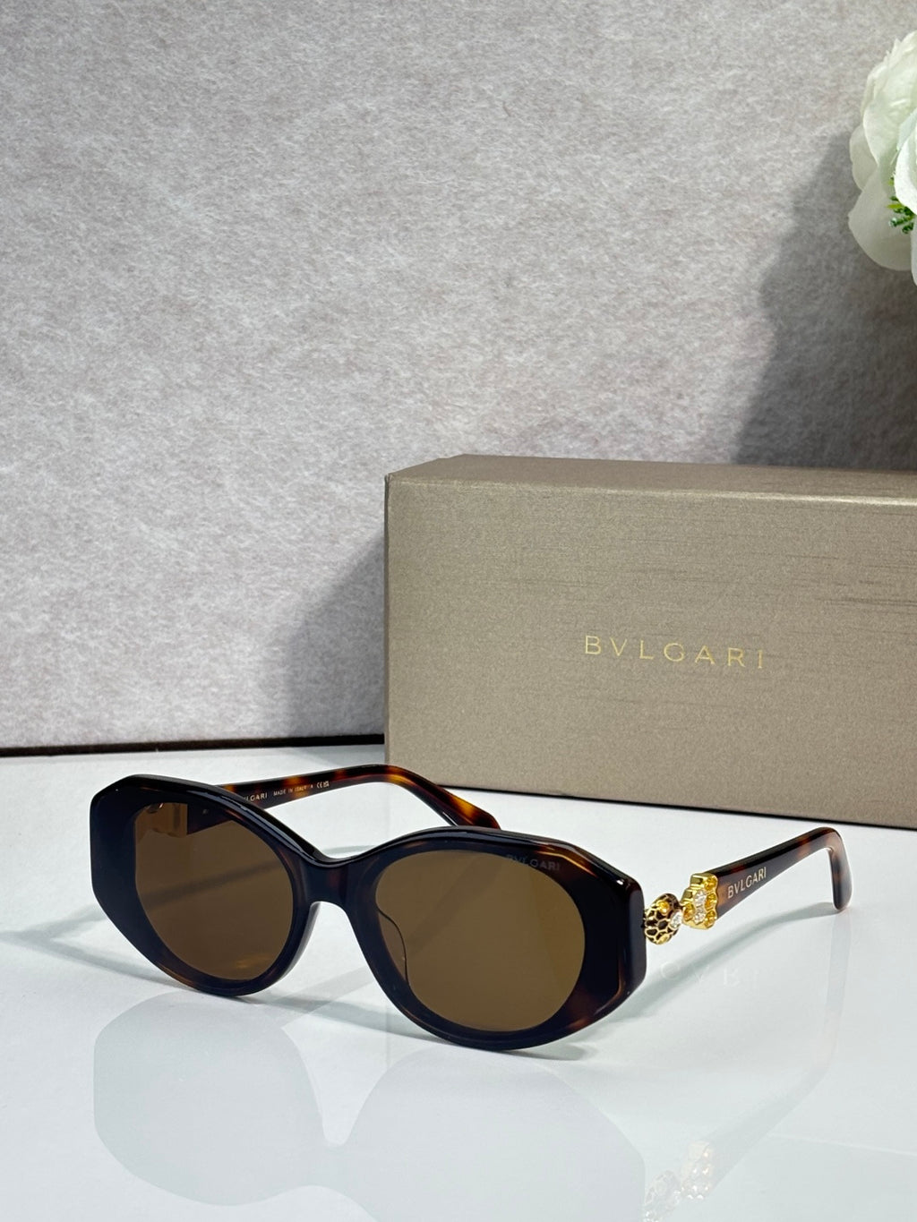 Bvlgari sunglasses with dark lenses and black round frames, tortoiseshell temple arms