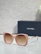 Chanel glasses with blush pink rounded frames, rose-tinted lenses, gold-tone temples