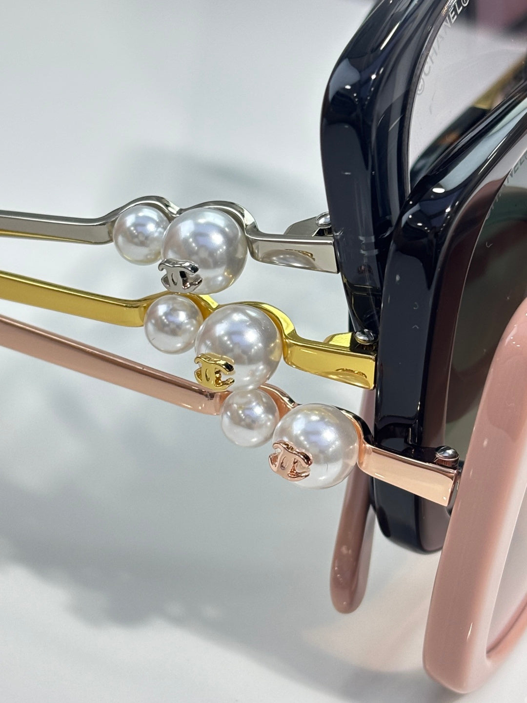 Chanel glasses detail with pearl-like ornaments and gold-tone metal temples