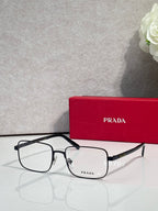Prada rectangular eyeglasses with dark frame and clear lenses, front view.