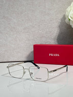 Prada rectangular eyeglasses with black frame and clear lenses, angled view.