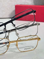 Prada rectangular eyeglasses set with silver and gold frames and clear lenses.