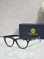 Versace optical glasses, dark blue frame with gold logo accents, clear lenses.