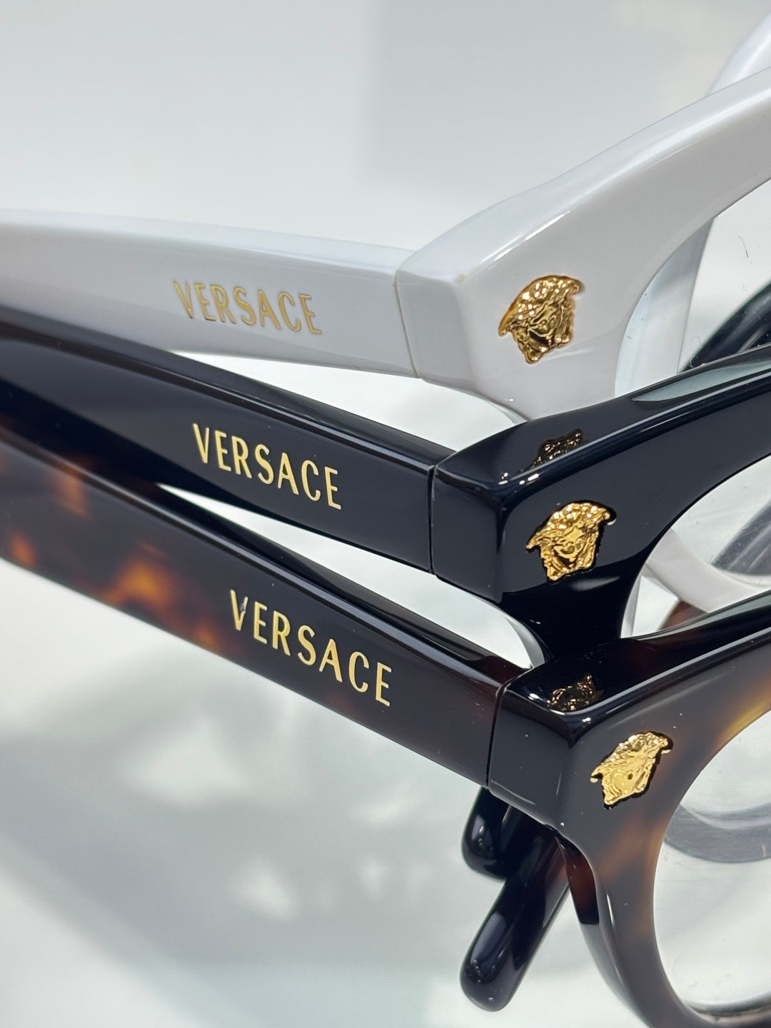Versace optical glasses, black temples with gold Medusa emblem and branding.