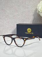Versace optical glasses, tortoiseshell frame with gold logo accents, clear lenses.