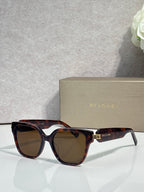 Tortoiseshell square sunglasses with amber-tinted lenses and BVLGARI logo temples