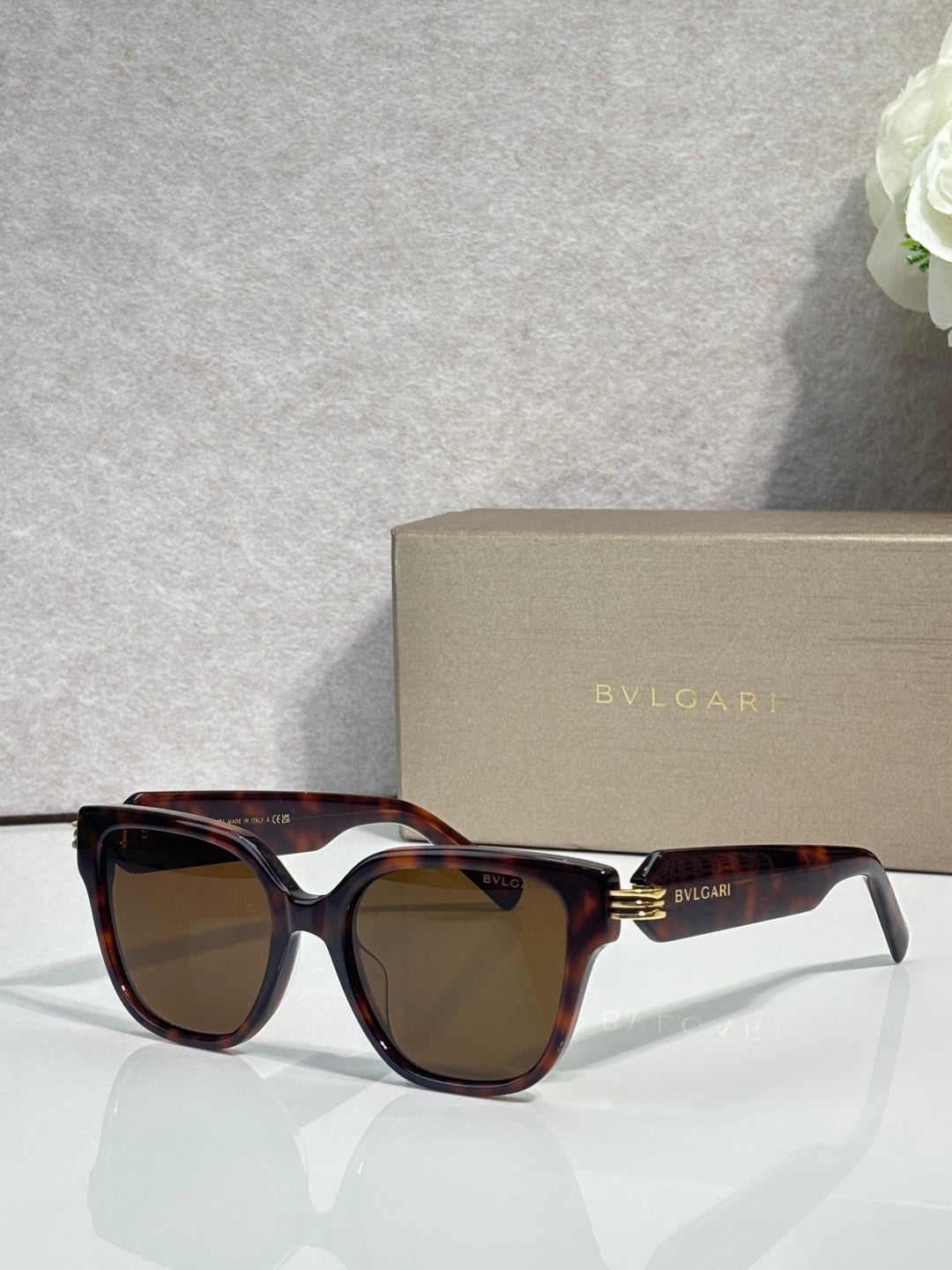 Tortoiseshell square sunglasses with amber-tinted lenses and BVLGARI logo temples