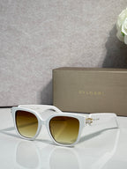 White square sunglasses with yellow-tinted lenses and gold-tone BVLGARI logo