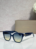 Blue square sunglasses with pale yellow-tinted lenses and gold-tone BVLGARI detail