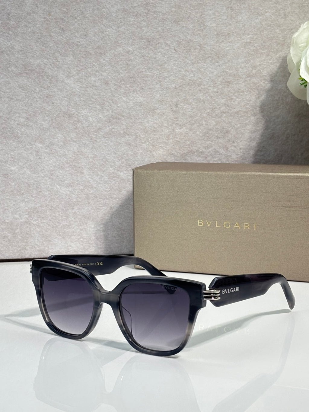 Dark navy square sunglasses with gradient lenses and gold-tone BVLGARI accents