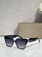 Dark navy square sunglasses with gradient lenses and gold-tone BVLGARI accents