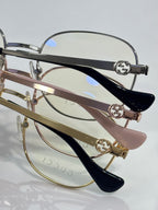 Round eyeglasses with dark navy temple arms and metal bridge hardware